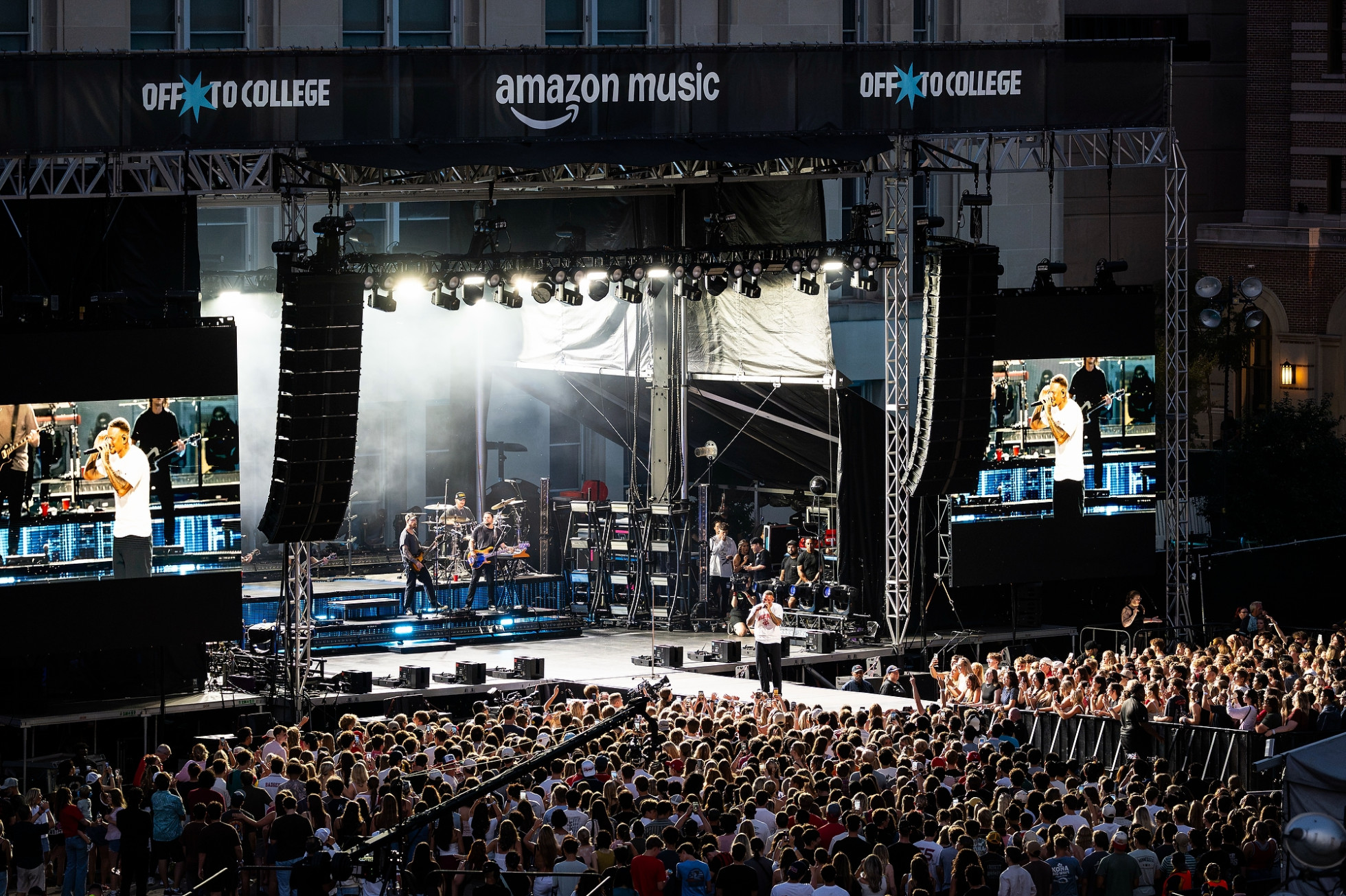 Kane Brown sings on stage in front of a large crowd.