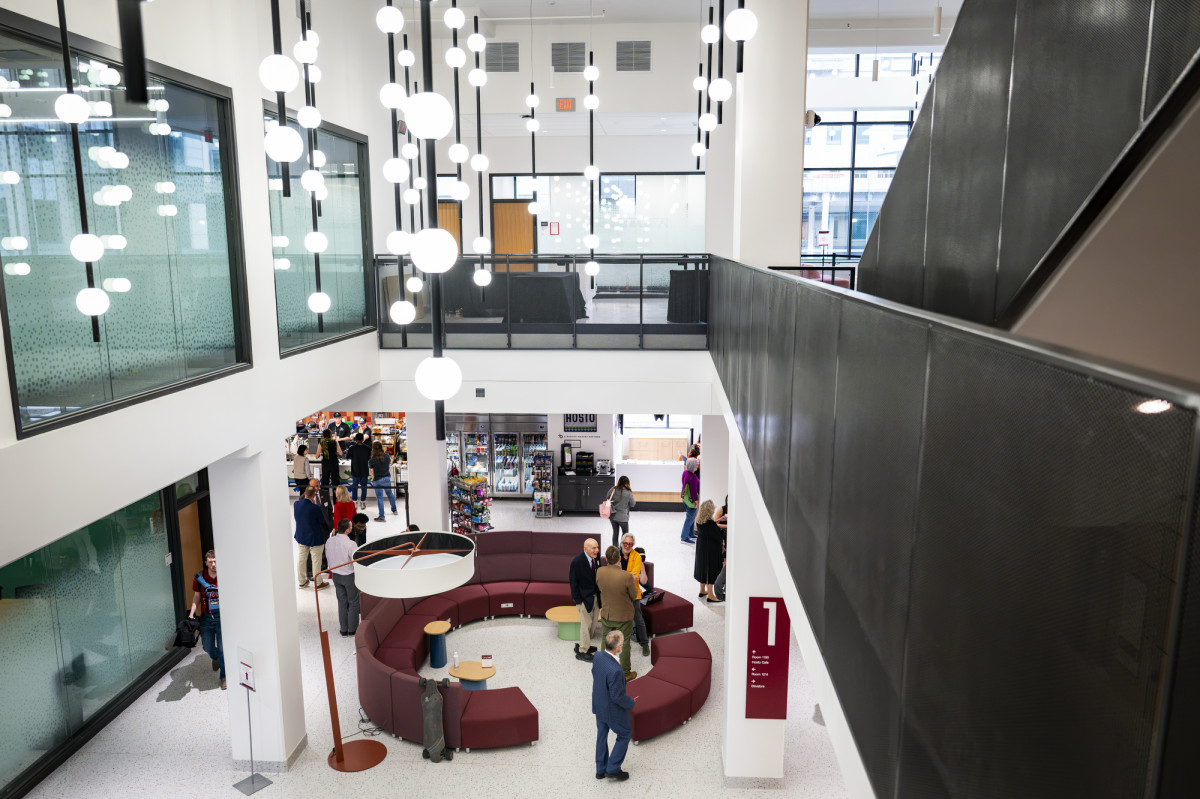 People mill around the common space on the first floor of Levy Hall before a ribbon-cutting ceremony.