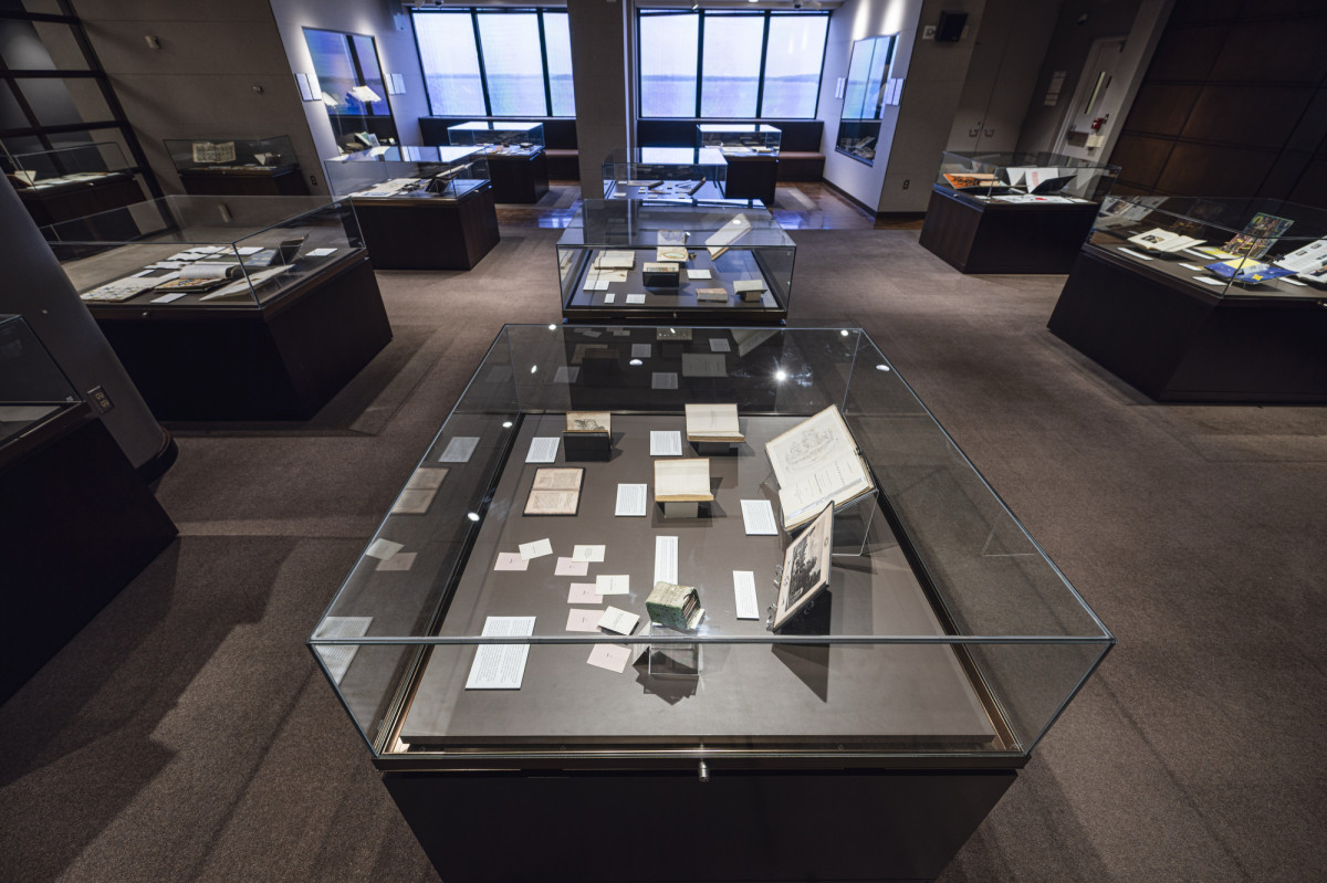 A wide-angle photo of the Special Collections exhibit, with artifacts contained in glass display cases.