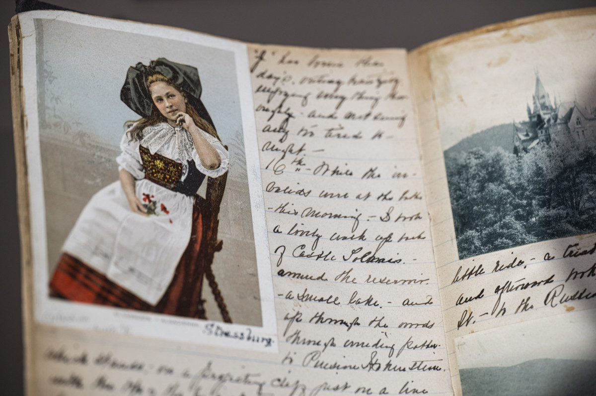 A notebook with hand-written notes and a portrait of a woman.
