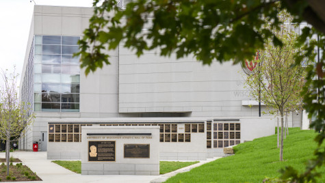 The UW Athletic Hall of Fame's concrete walls and bronze plaques, with the Kohl Center in the background.