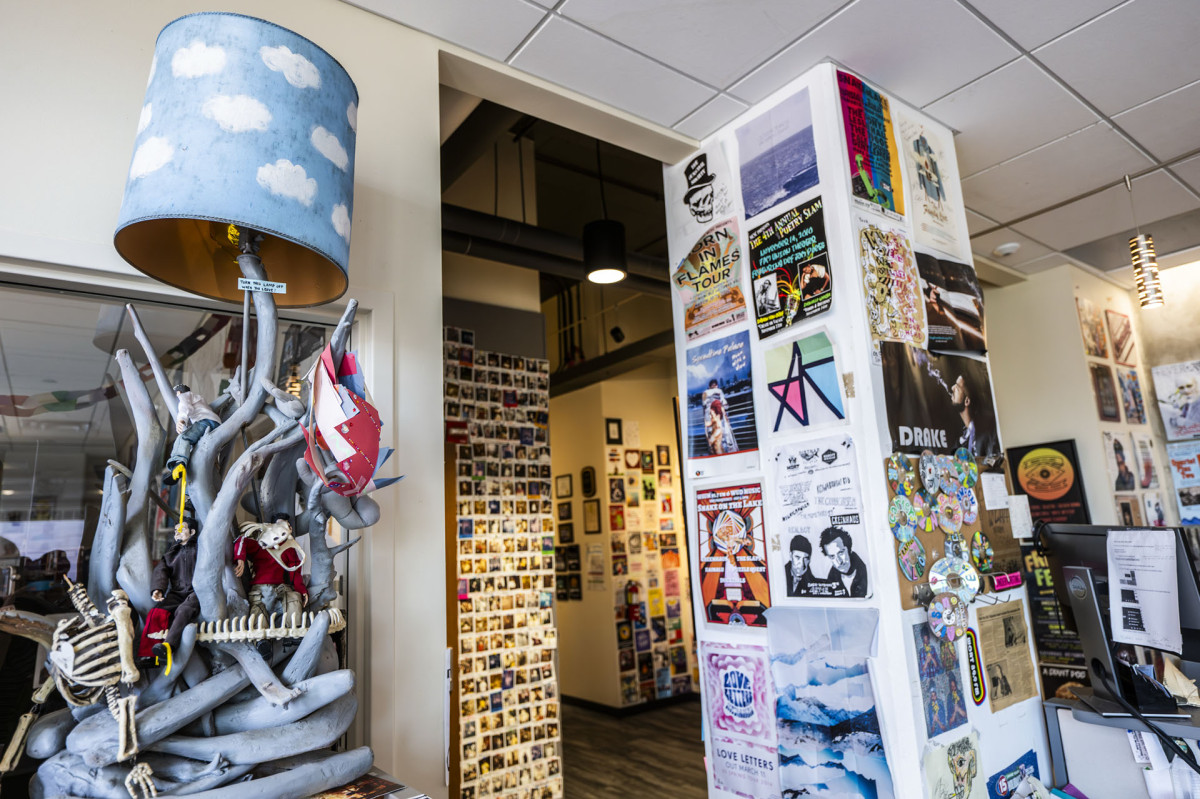 Novelty lamp, artistic posters and a wall full of polaroids decorate the inside of the the WSUM studio