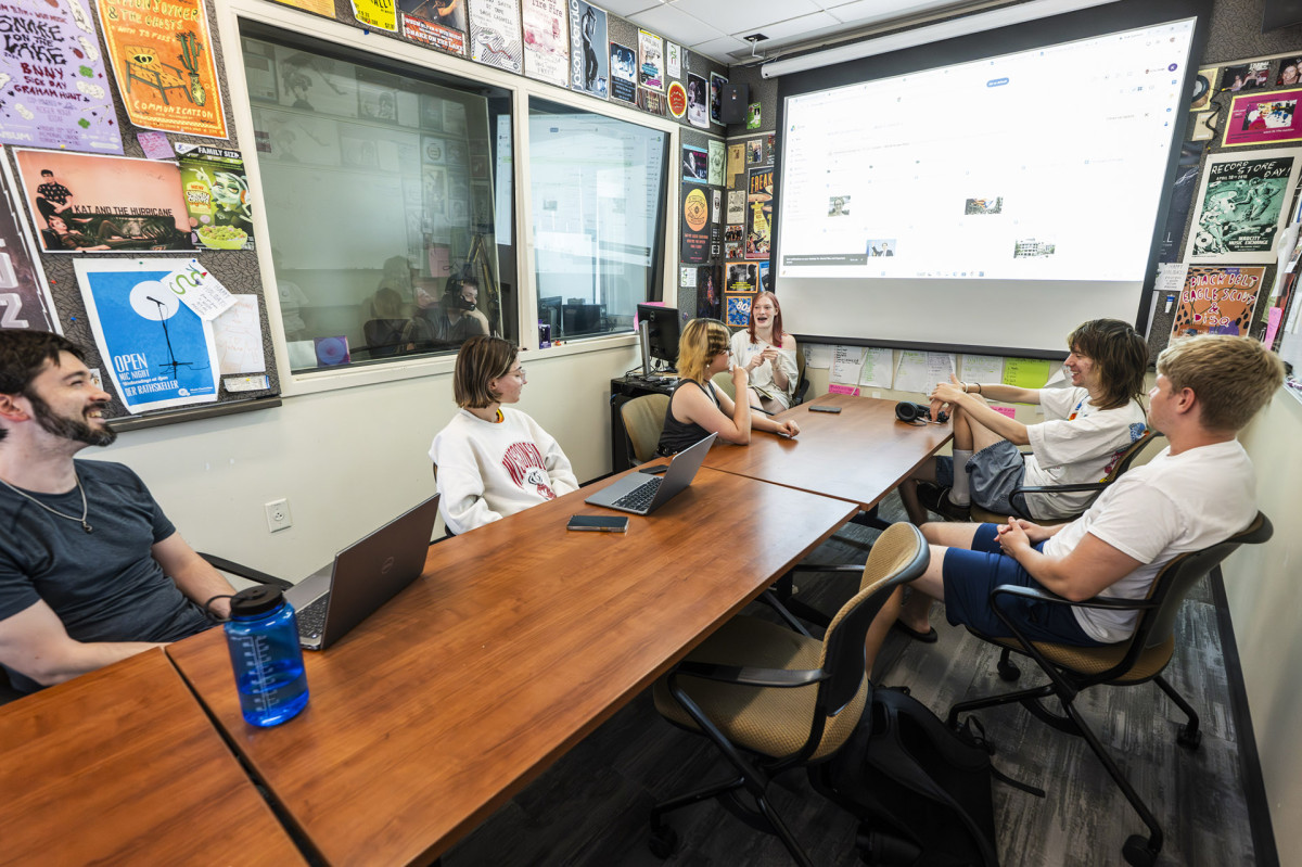 A group of WSUM employees chat around a conference table