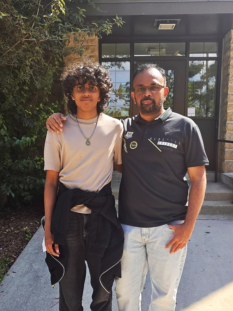 Student Adityan Thirumani Srinivasan pictured with his father in front of a building