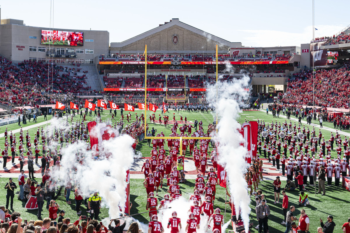 The UW football team runs onto the field at Camp Randall Stadium