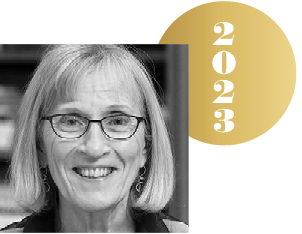 Black and white headshot of Claudia Goldin with an overlapping gold circle representing a Nobel medal, with the year 2023 on it.