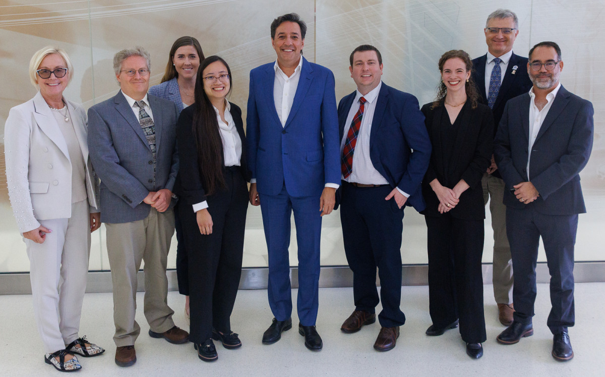 Darío Gil, center, under secretary for science at the U.S. Department of Energy, poses with University of Wisconsin–Madison recipients of DOE Genesis awards and campus and DOE leaders at the Wisconsin Energy Institute.