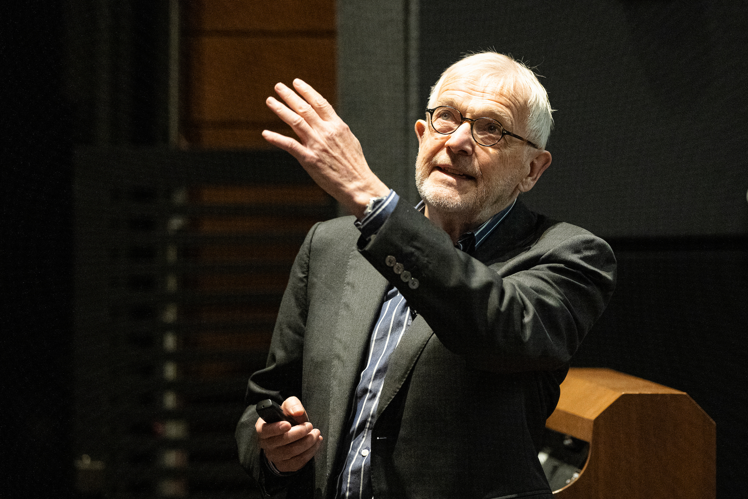 Professor Francis Halzen points toward a screen while giving a presentation.