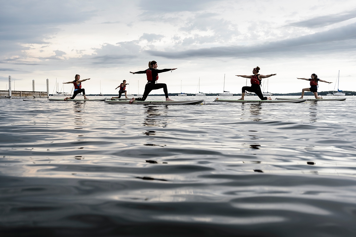 Photo from 2016 of stand-up paddle boarding yoga